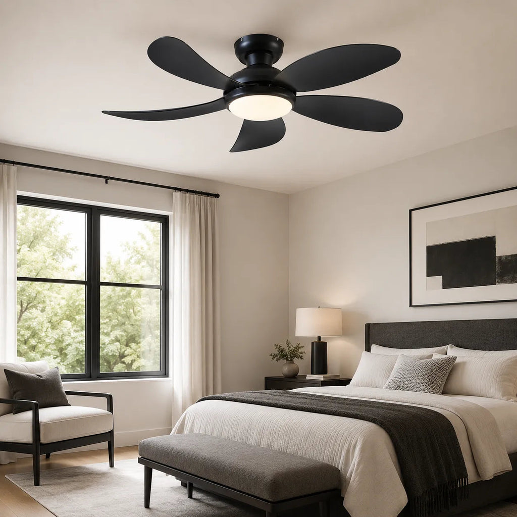 Black 42 inch flush mount ceiling fan with light installed in a modern bedroom